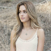 woman wearing moonstone wire wrapped pendant