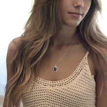 woman wearing lapis lazuli pendant