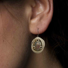 woman wearing purple labradorite earrings