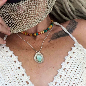 woman wearing larimar pendant