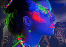 woman wearing glow in the dark glass earrings