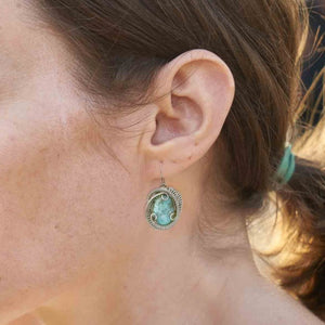 woman wearing larimar earrings